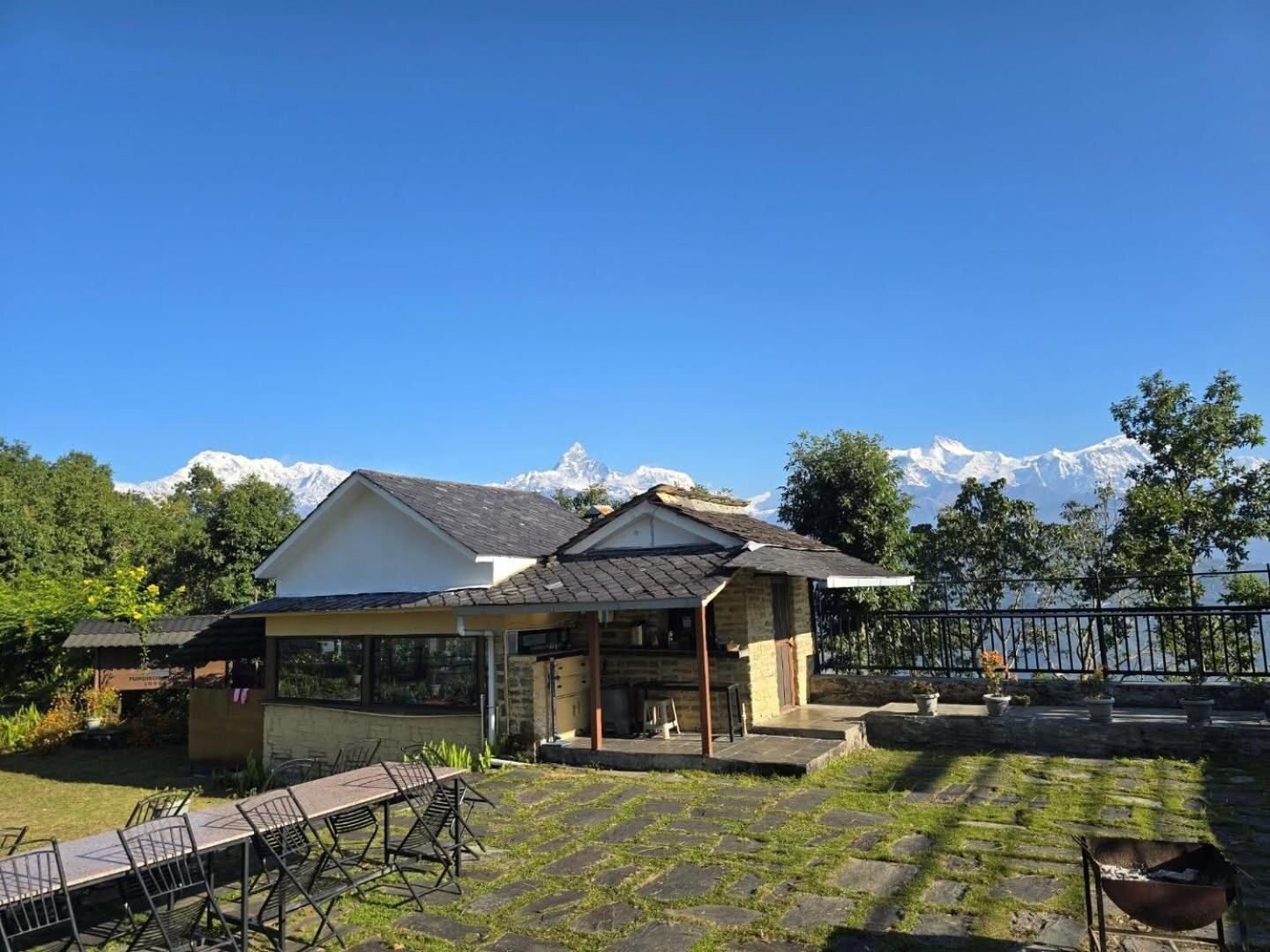 The lodge framed by the Annapurna range